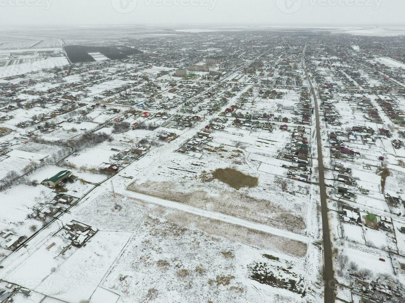 Winter view from the bird's eye view of the village. The streets are covered with snow photo