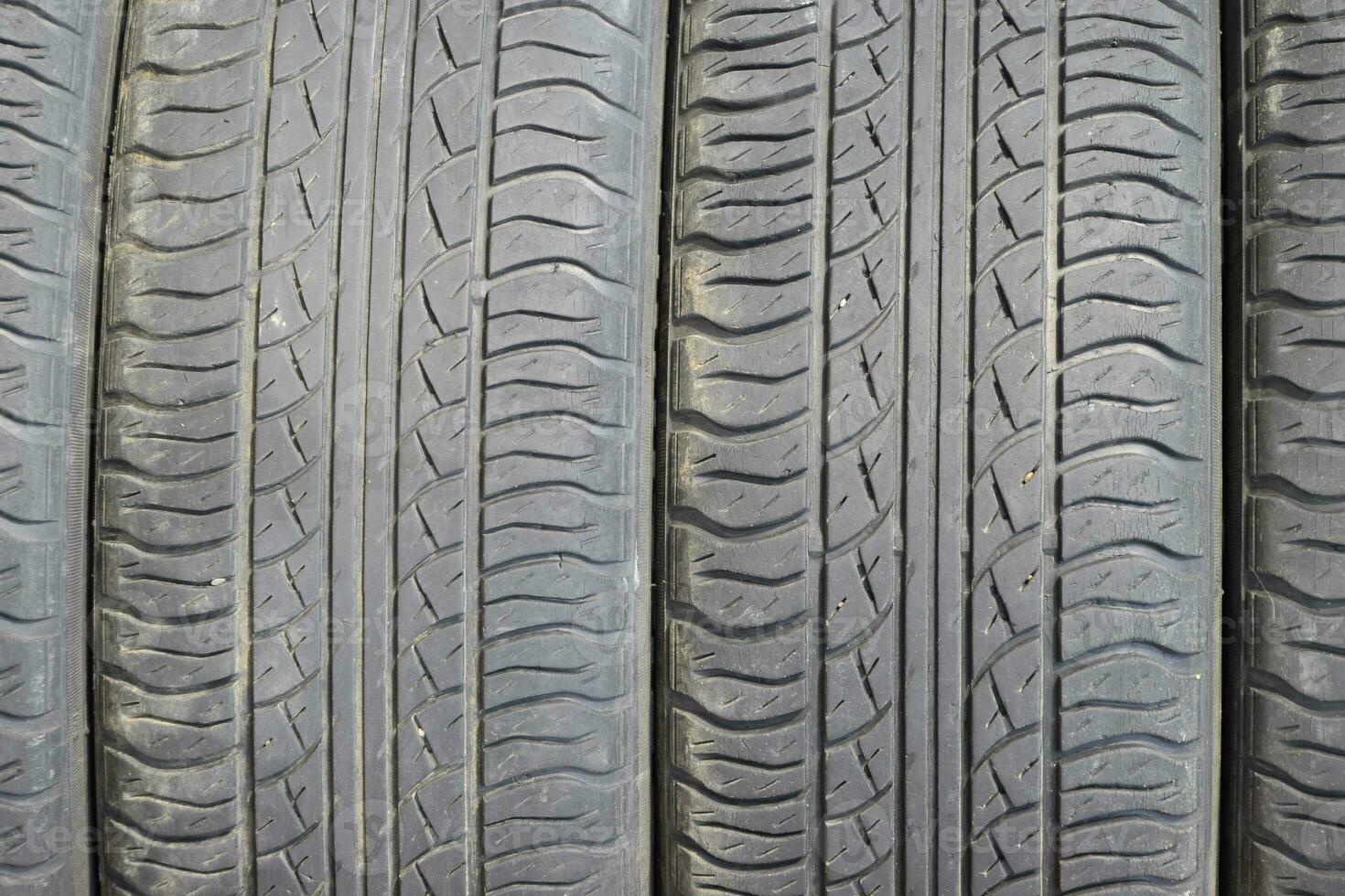 The background of the tread pattern of the car wheel. Rubber tir photo