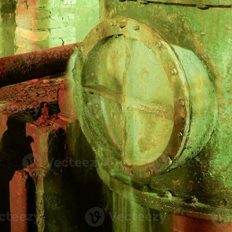 Leakage in the hatch on the pipe. Old equipment. Basement of a w photo