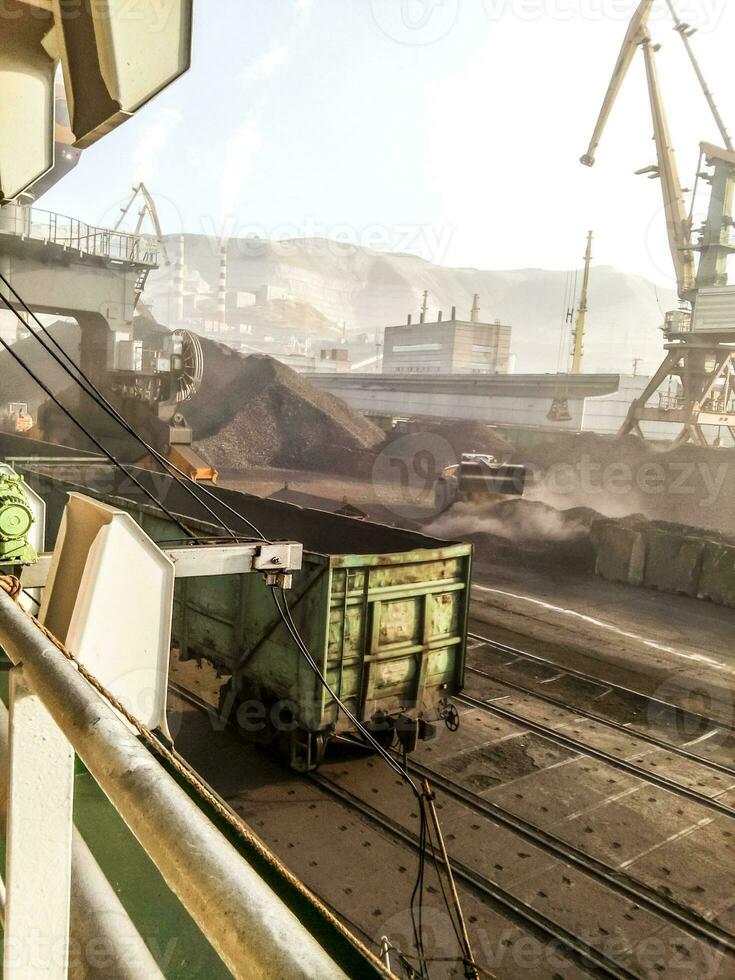 Cargo industrial port, port cranes. Loading of anthracite. Transportation of coal. Heap of coal photo