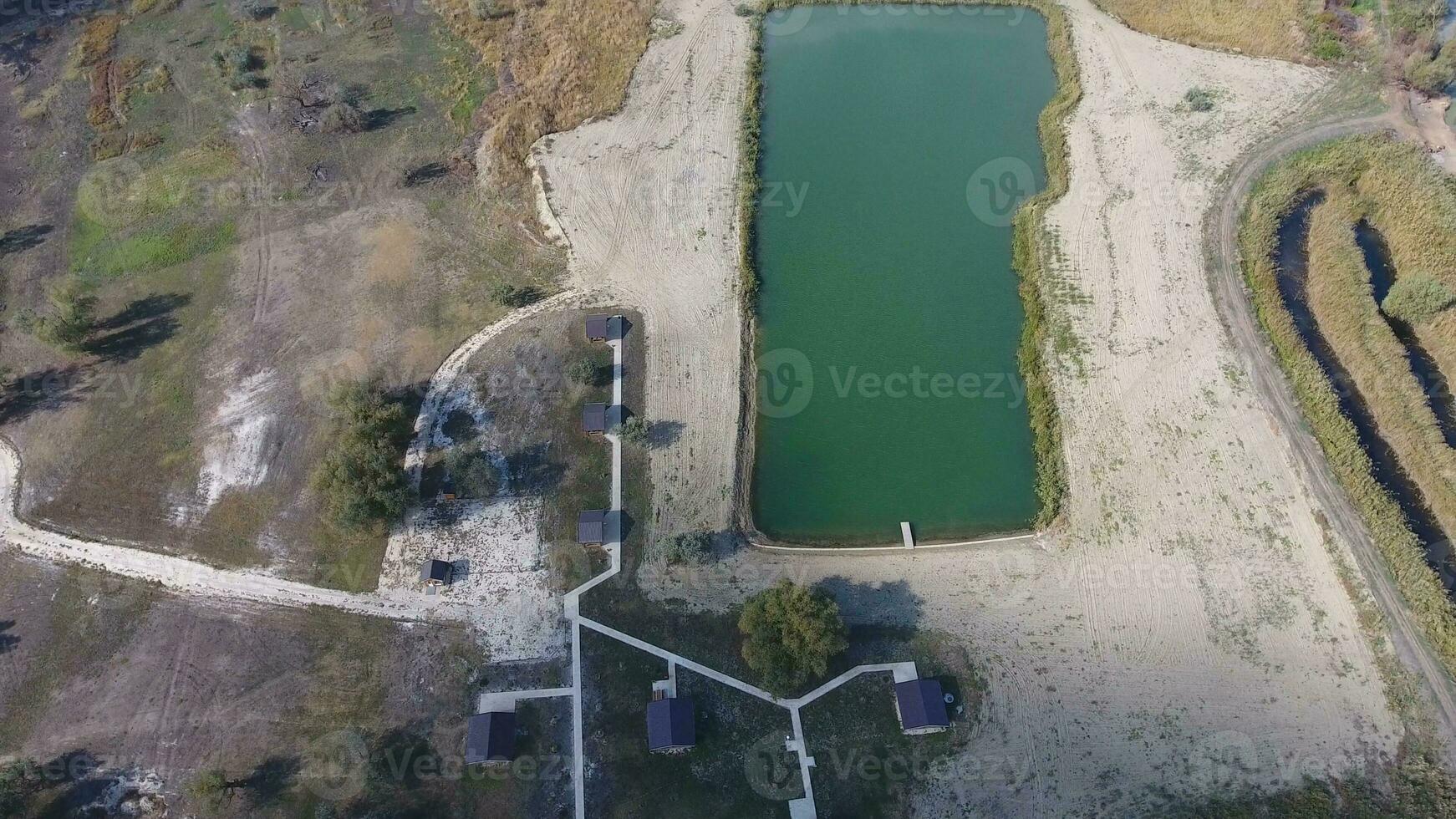 An artificial lake for fishing. A bridge for fishermen on the lake. Lake fishing. photo