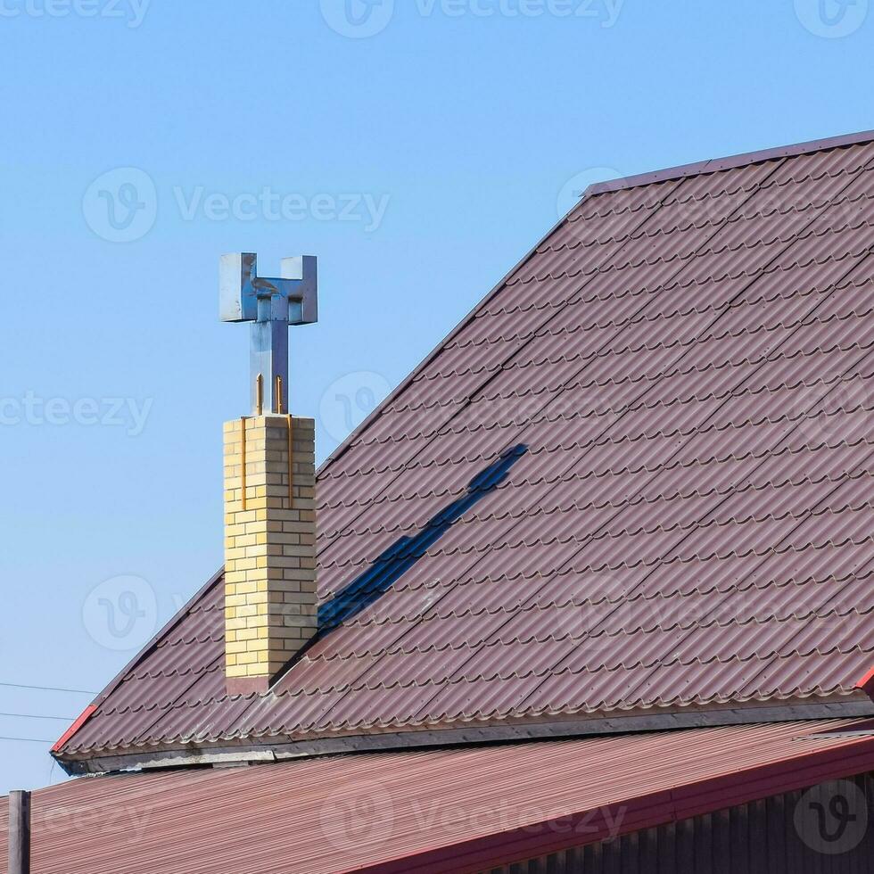 The roof of corrugated sheet. Brown corrugated metal profile roof. photo