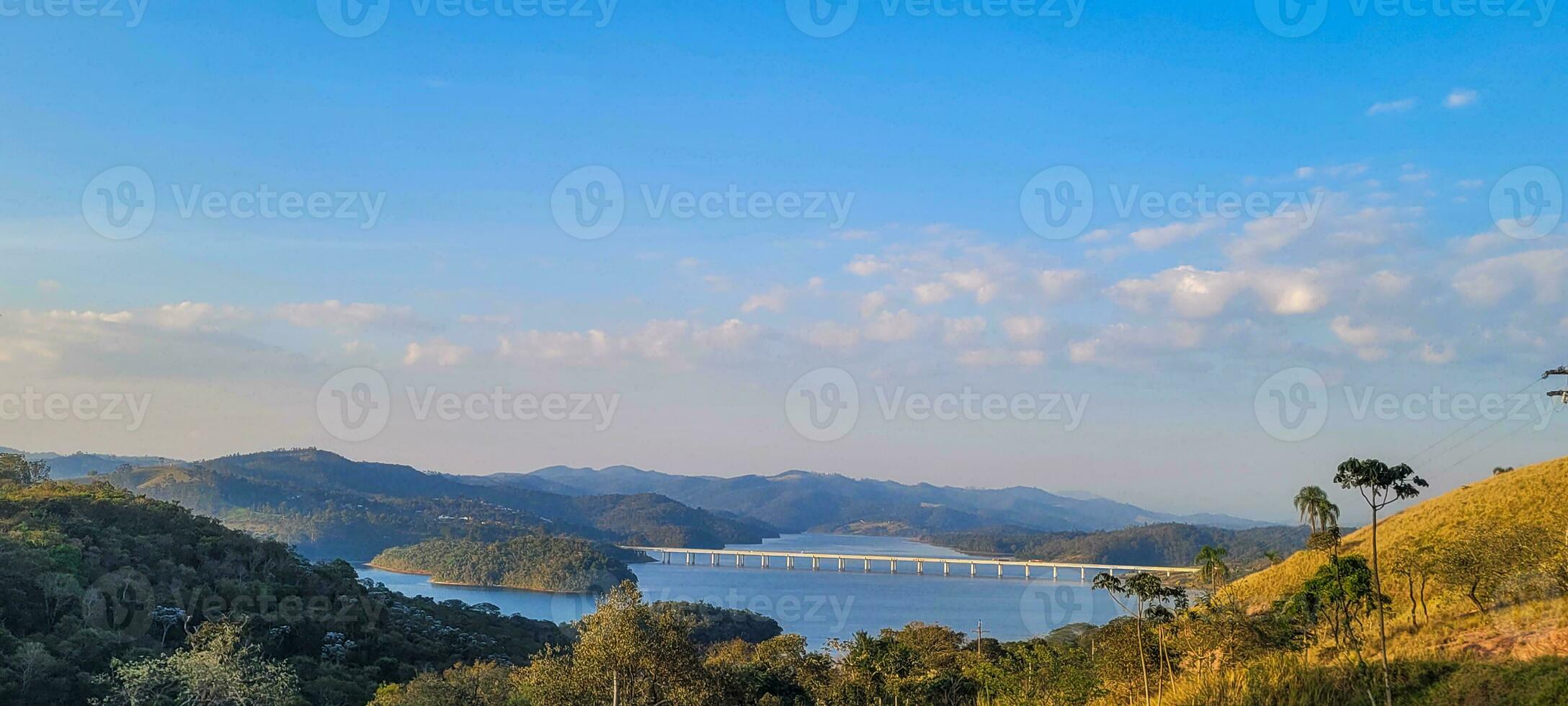 Serene lake in the mountains of Brazil lush and tranquil setting, natural beauty that enchants. Highlight your creativity with this stunning view photo