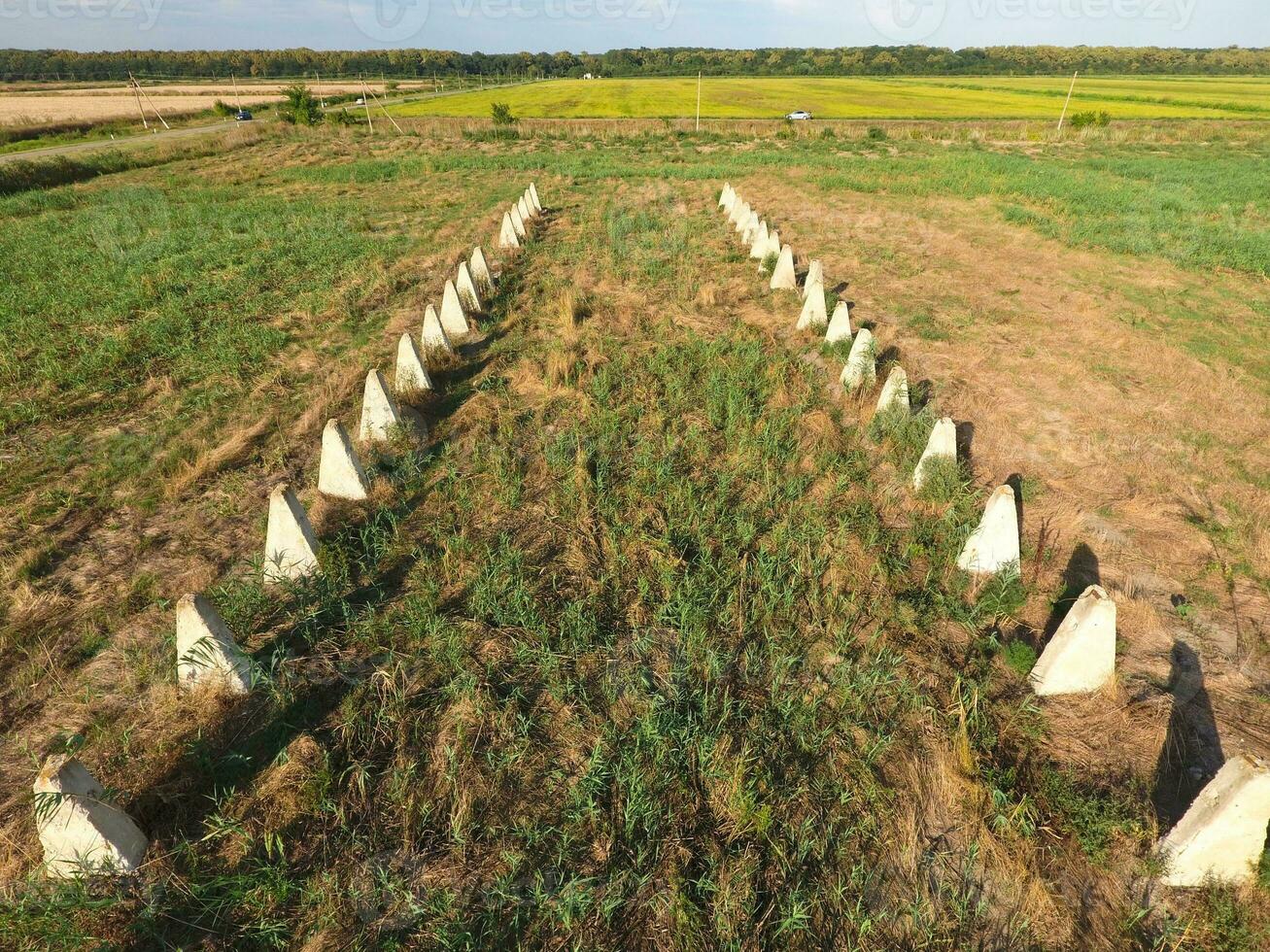 The ruins of the old farm. Cones column base of the wall. Abandoned and ruined buildings photo