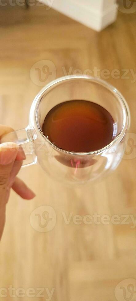 Enjoy the moment with the elegance of this coffee cup in a woman's hands. Warmth and flavor in every detail. Get this irresistible image now photo