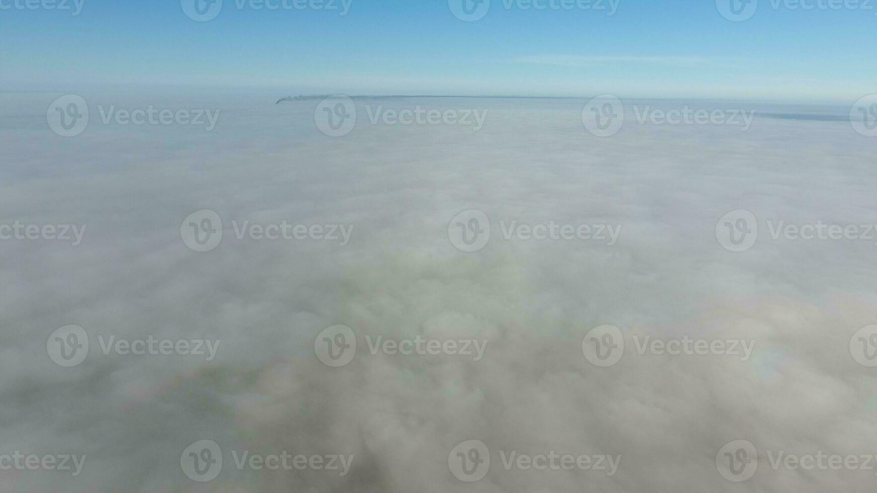 Fog above the ground. Top view of the fog. Low clouds. Morning mist condensation. Shooting with a drone photo