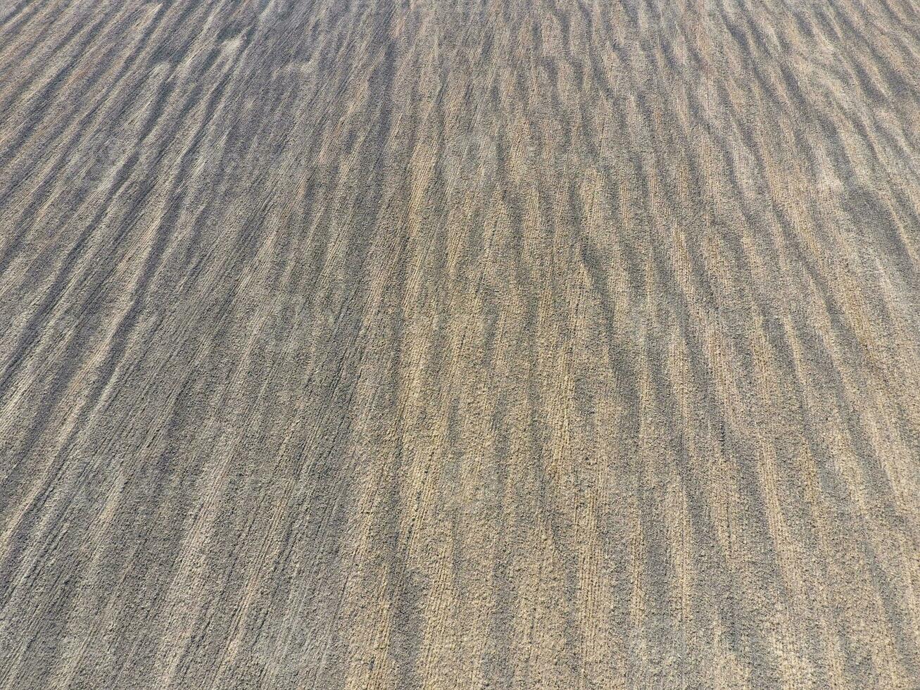 Top view of a plowed field. Background texture of the surface of the plowed field. Shooting with quadrocopters photo