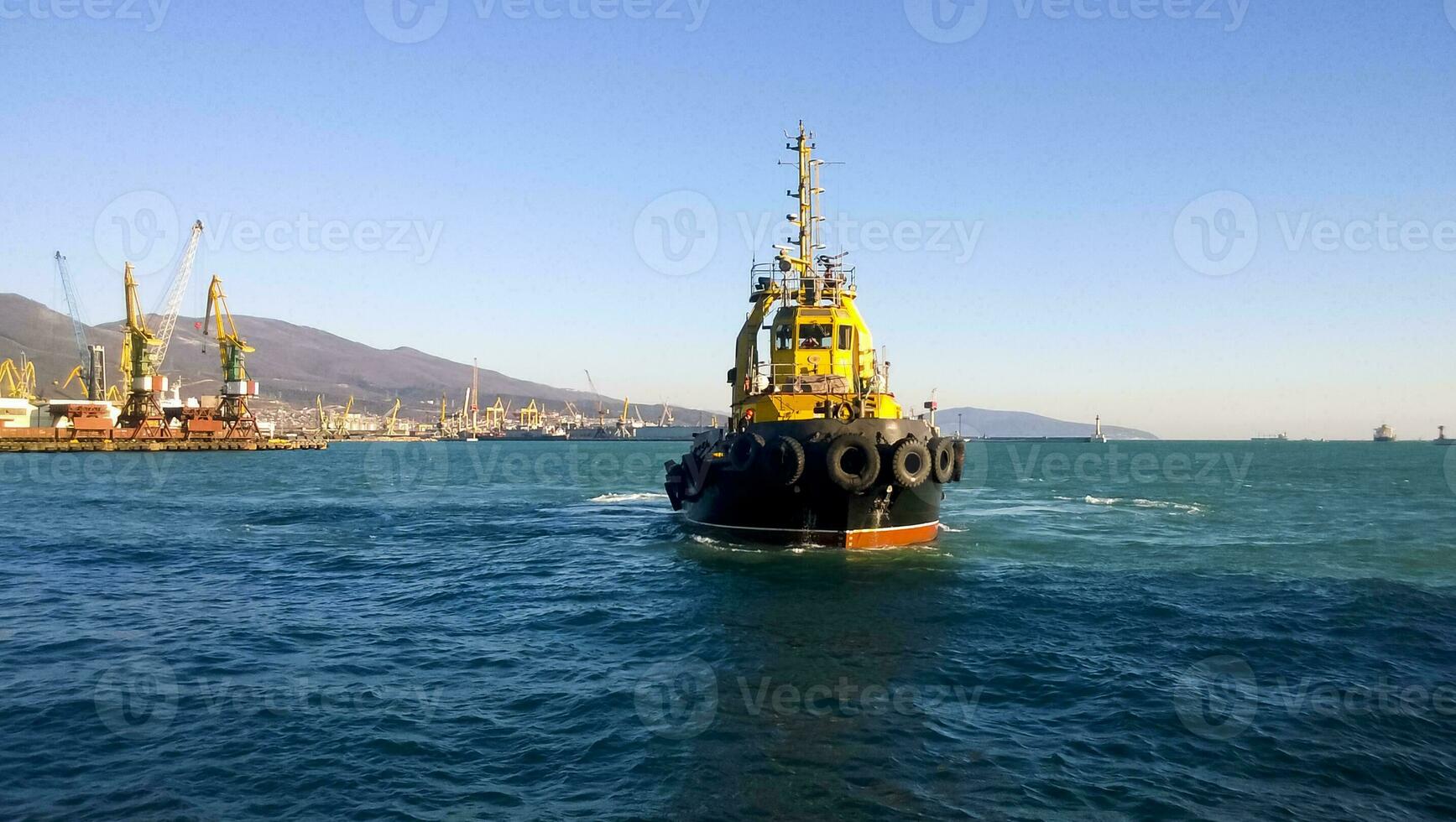 A small service ship in a cargo industrial port. A ship in the sea photo