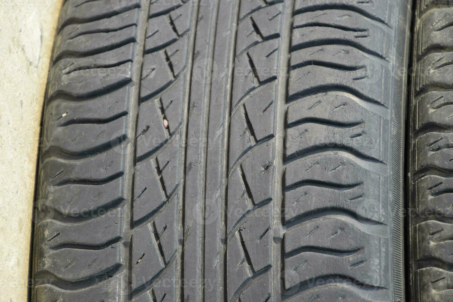 The background of the tread pattern of the car wheel. Rubber tir photo