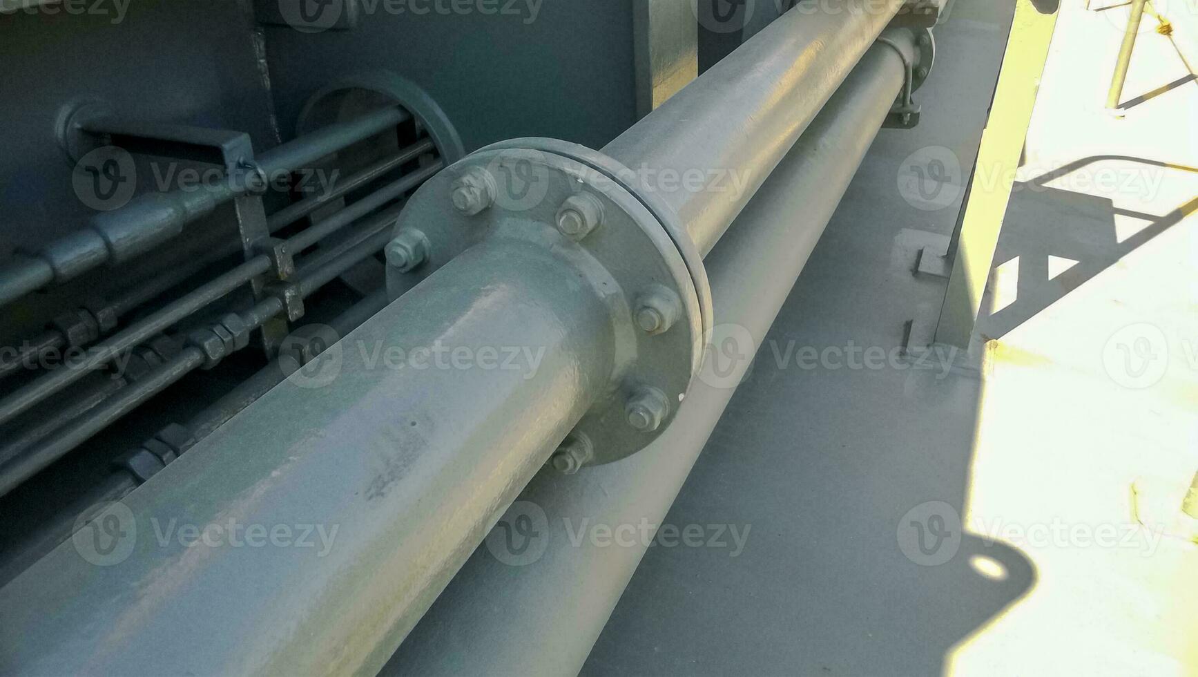 Flanged connection on a gray pipe. Pipes on the deck of the ship photo