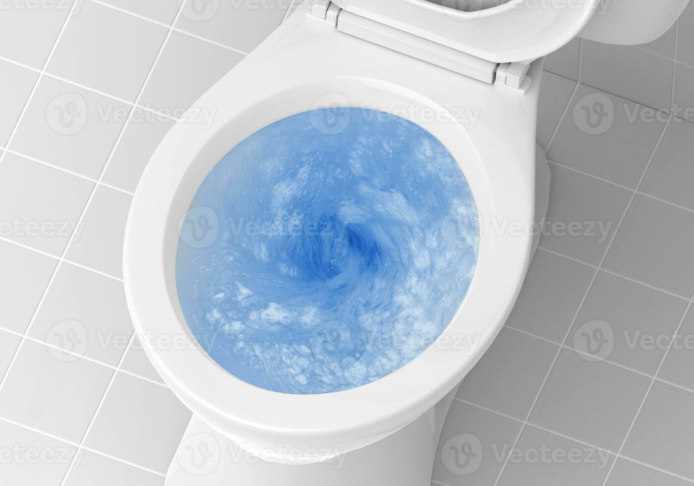 Top view of toilet bowl, blue detergent flushing in it photo