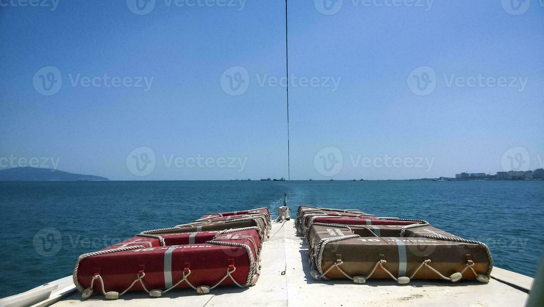 The bow of the boat with survival squares for 16 people. Sea port. photo