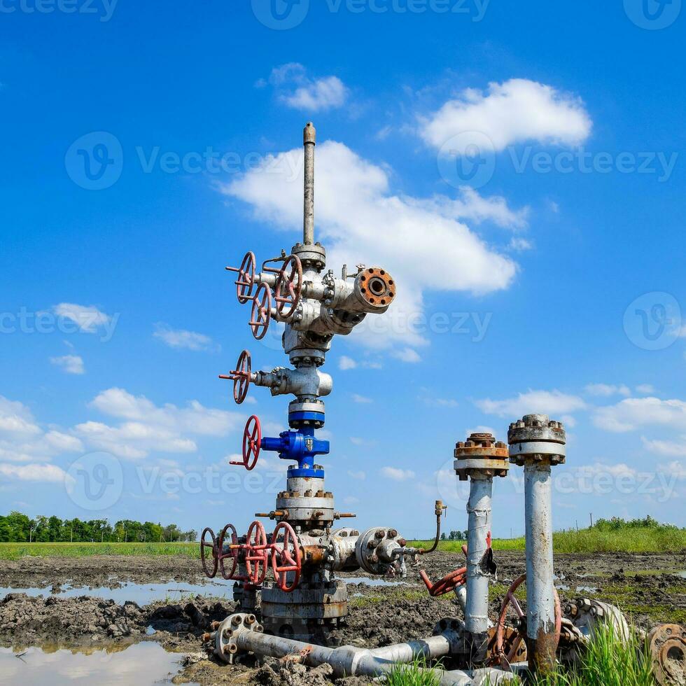 Oil well after repair in mud and puddles. photo