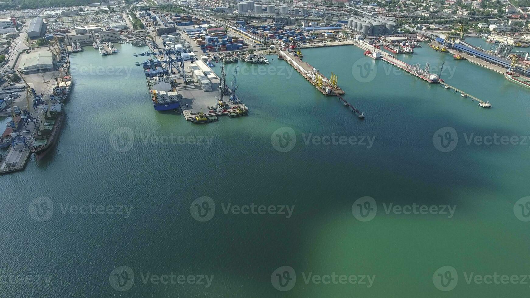Industrial seaport, top view. Port cranes and cargo ships and barges. photo