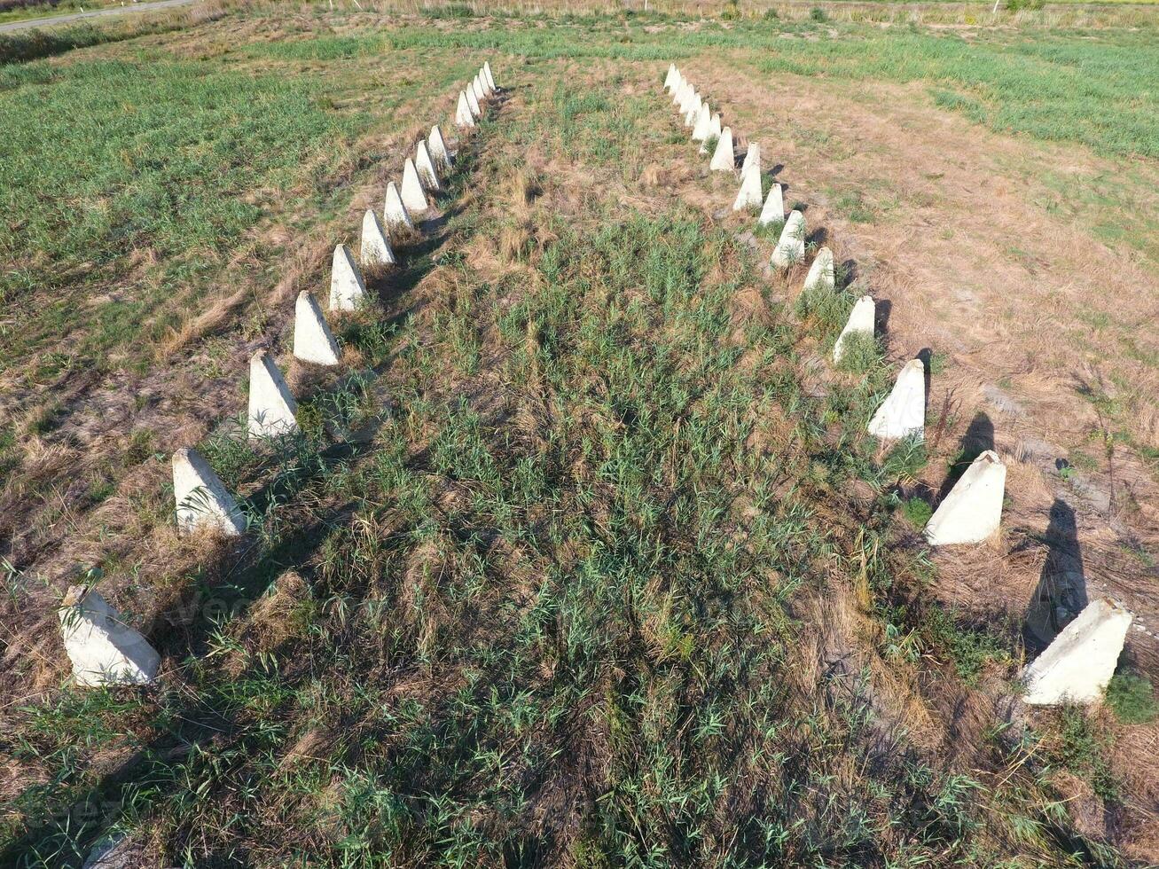 The ruins of the old farm. Cones column base of the wall. Abandoned and ruined buildings photo