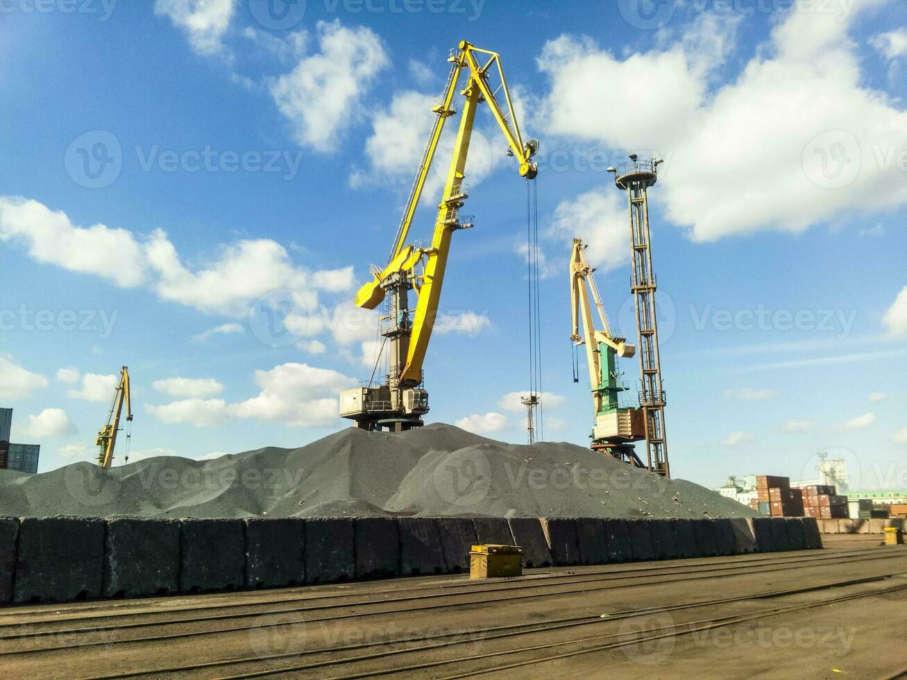 Cargo industrial port, port cranes. Loading of anthracite. Transportation of coal. Heap of coal photo