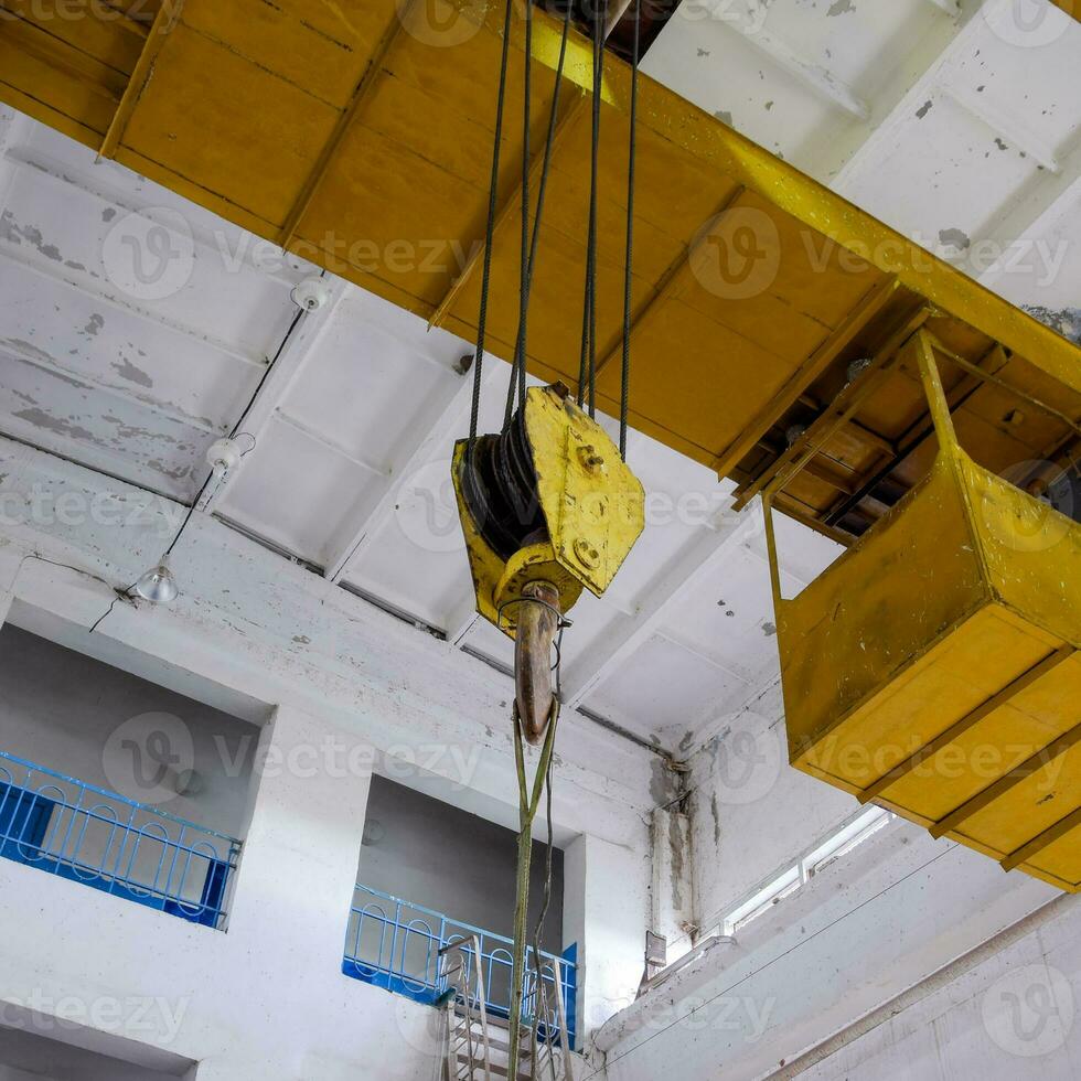 Hoist with winch and hook. A tool for moving goods in a producti photo