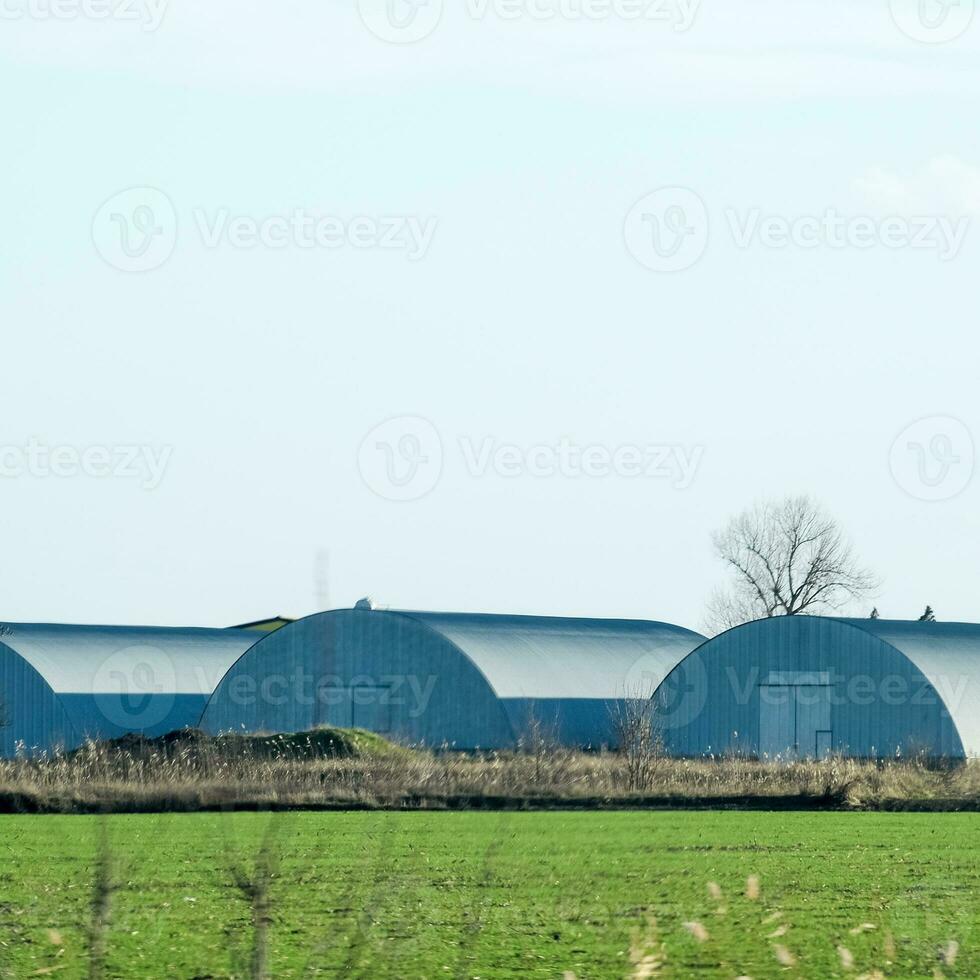 Three hangars in the field. Hangars from galvanized iron. photo