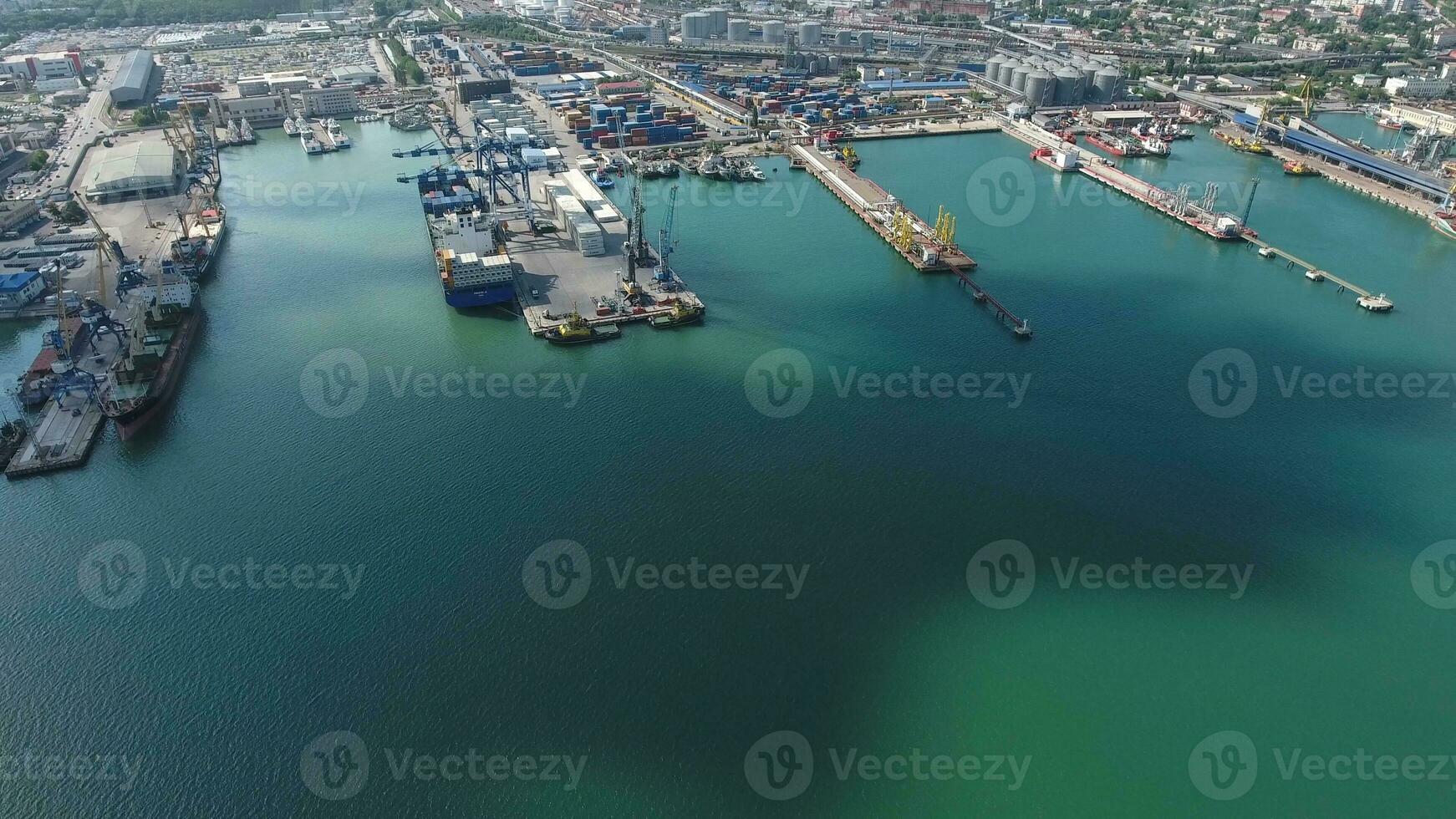 Industrial seaport, top view. Port cranes and cargo ships and barges. photo