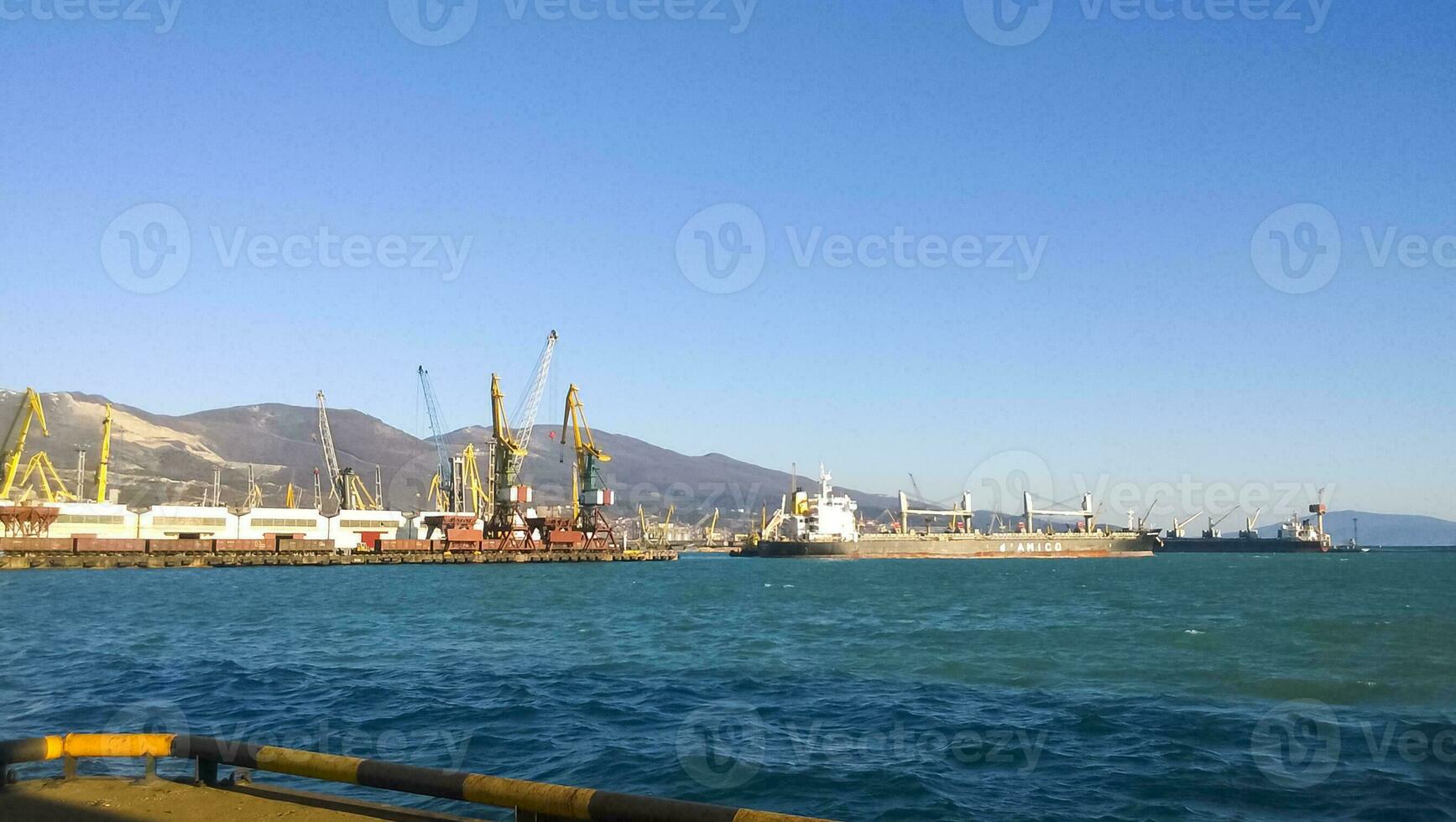 Port landscape. View of the industrial port. The sea, port cranes and ships photo