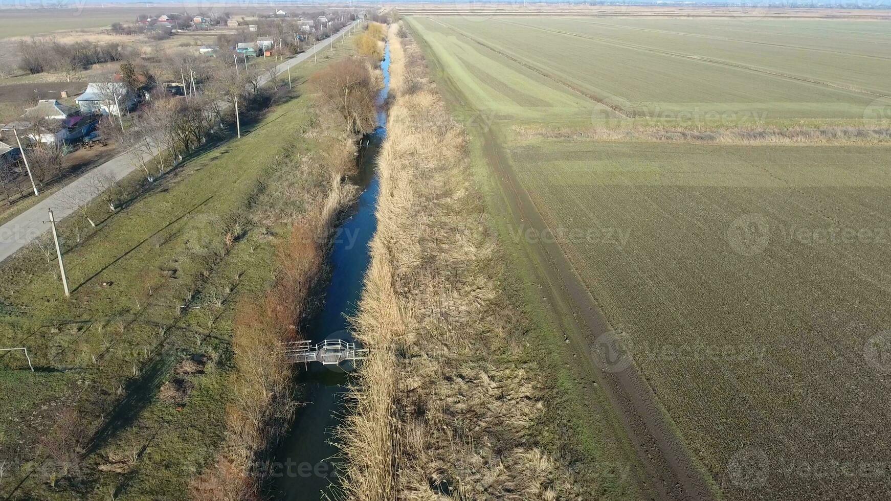 The channel of the lower level of the irrigation system of fields. Infrastructure for the cultivation of rice photo