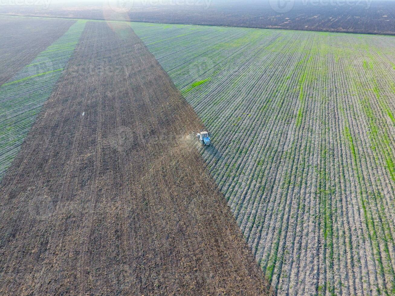 Top view of the tractor that plows the field. disking the soil. Soil cultivation after harvest photo