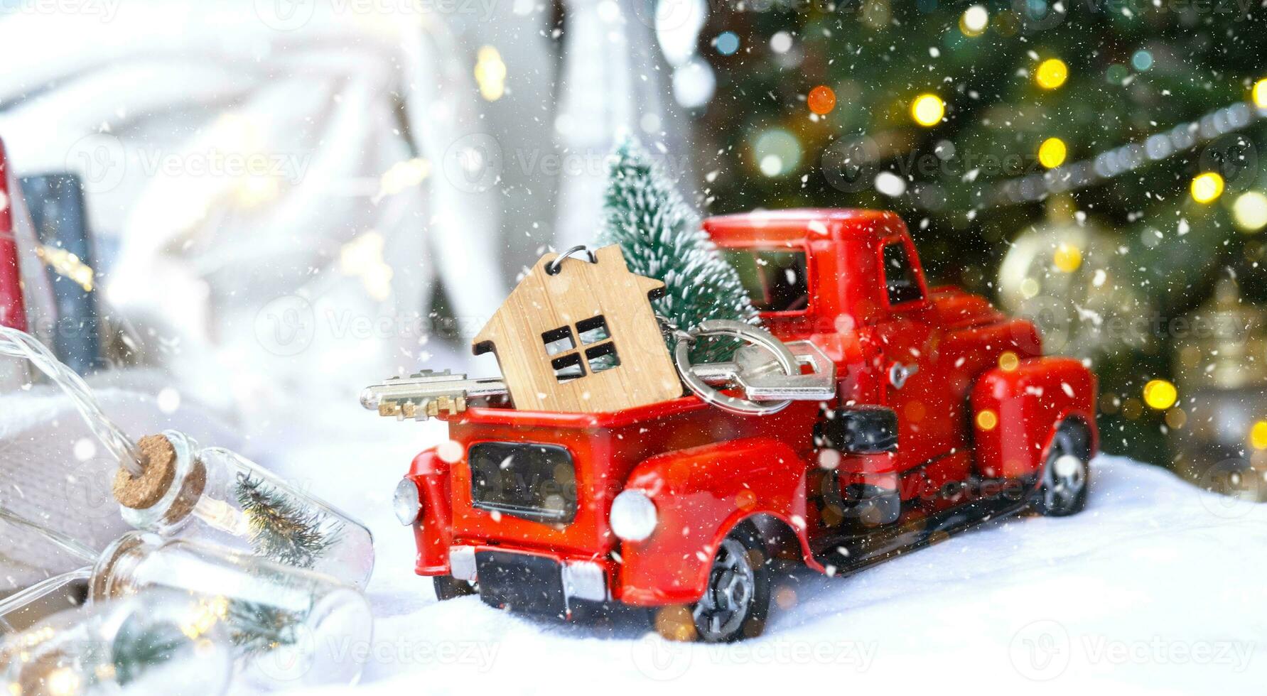 Red retro car with a Christmas tree decorates with the house key in the pickup truck for Christmas. Buying a home, moving, mortgage, loan, real estate, festive mood, New Year photo