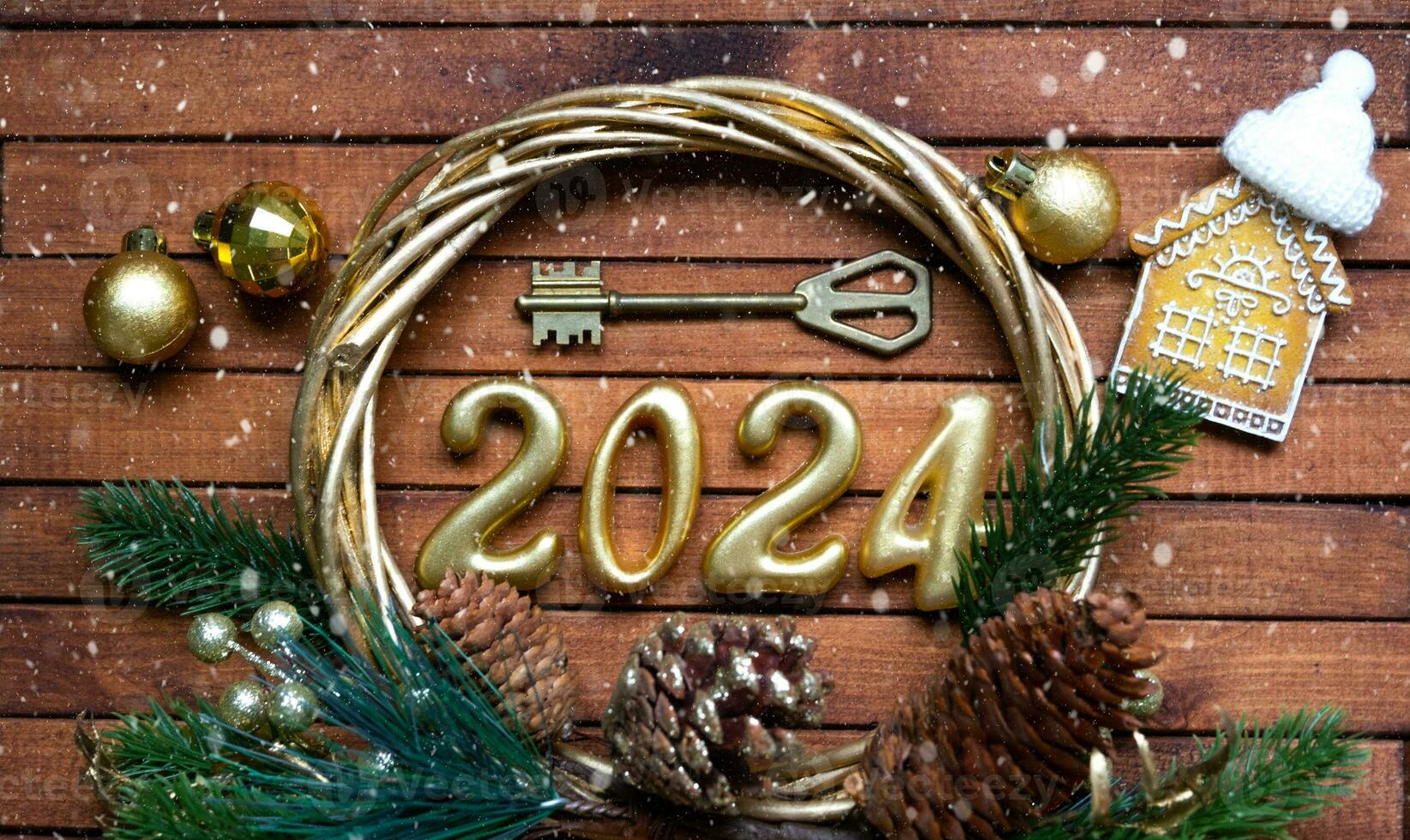 House key with keychain cottage on festive brown wooden background with stars, lights of garlands. New Year 2024 wooden letters, greeting card. Purchase, construction, relocation, mortgage, insurance photo