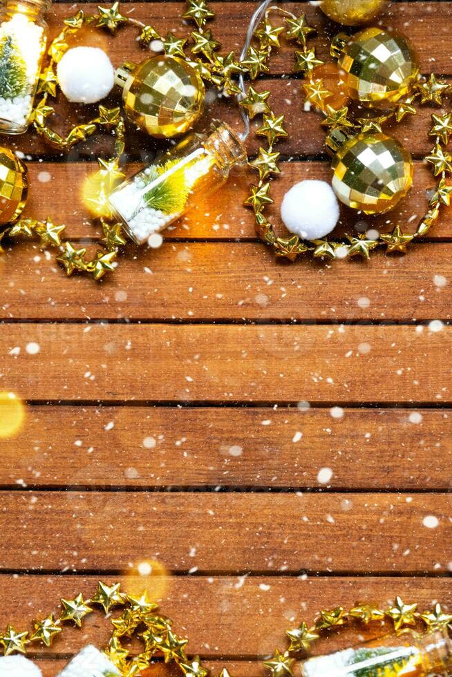Festive frame with a place for Christmas and New Year's theme text. Sequins, stars, garland on brown wooden background. Copyspace, greeting card photo