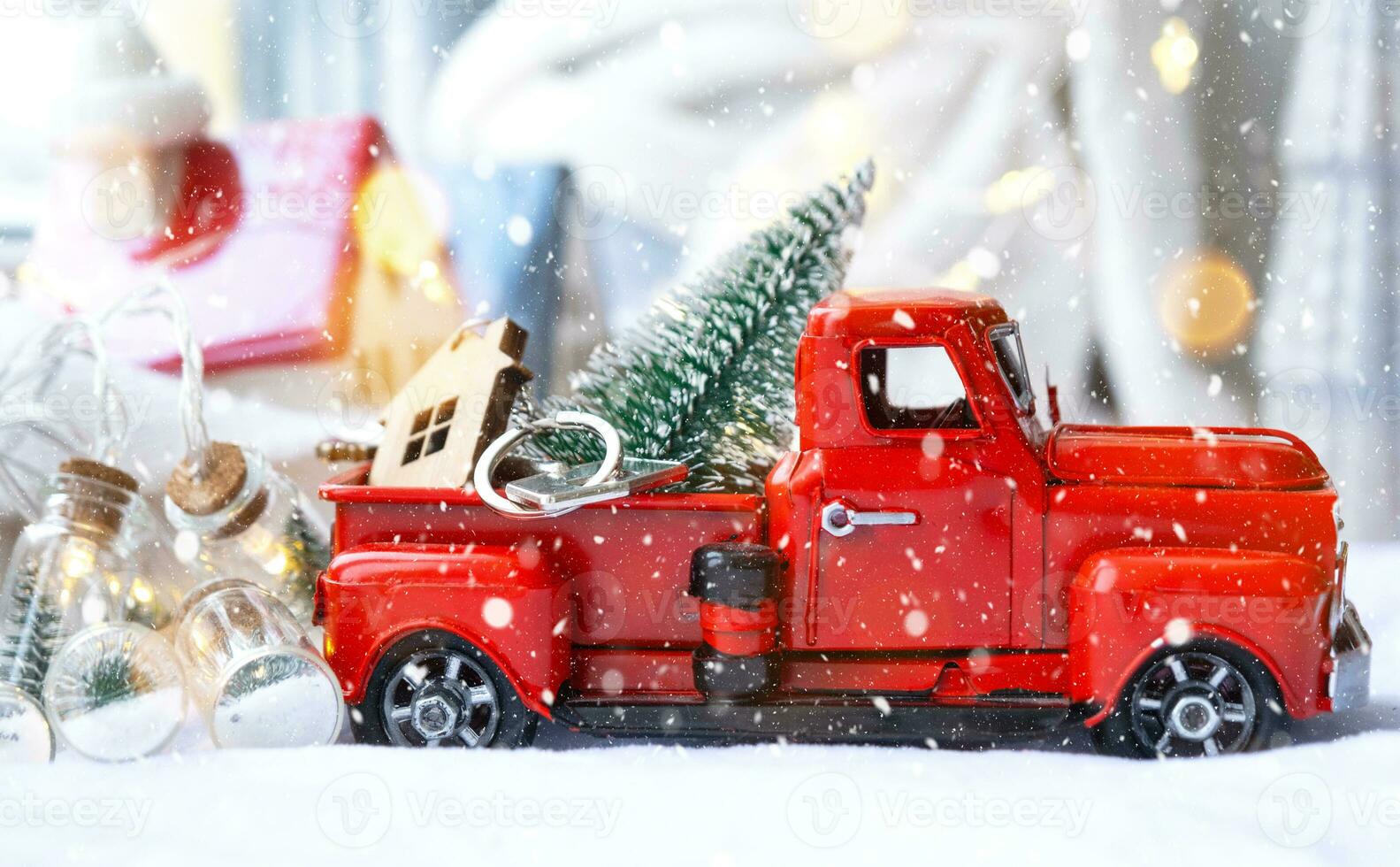 Red retro car with a Christmas tree decorates with the house key in the pickup truck for Christmas. Buying a home, moving, mortgage, loan, real estate, festive mood, New Year photo