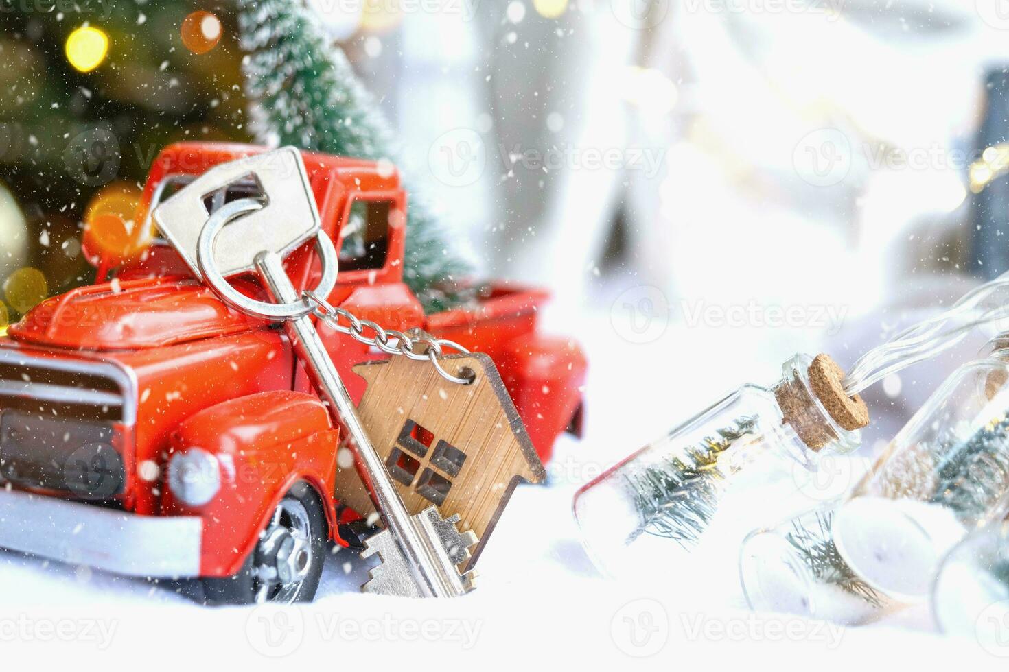 Red retro car with a Christmas tree decorates with the house key in the pickup truck for Christmas. Buying a home, moving, mortgage, loan, real estate, festive mood, New Year photo