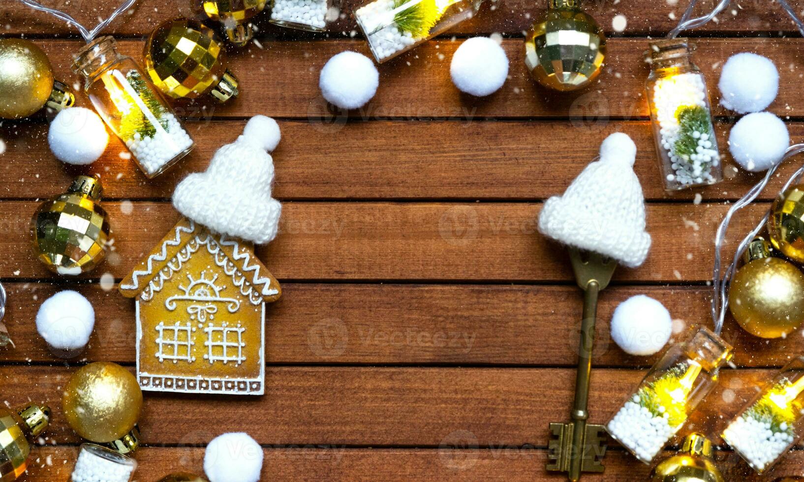 Key to house with a keychain tiny home on wooden background with Christmas decor layout. Gift for New Year, Christmas. Building, project, moving to new house, mortgage, rent and purchase real estate photo