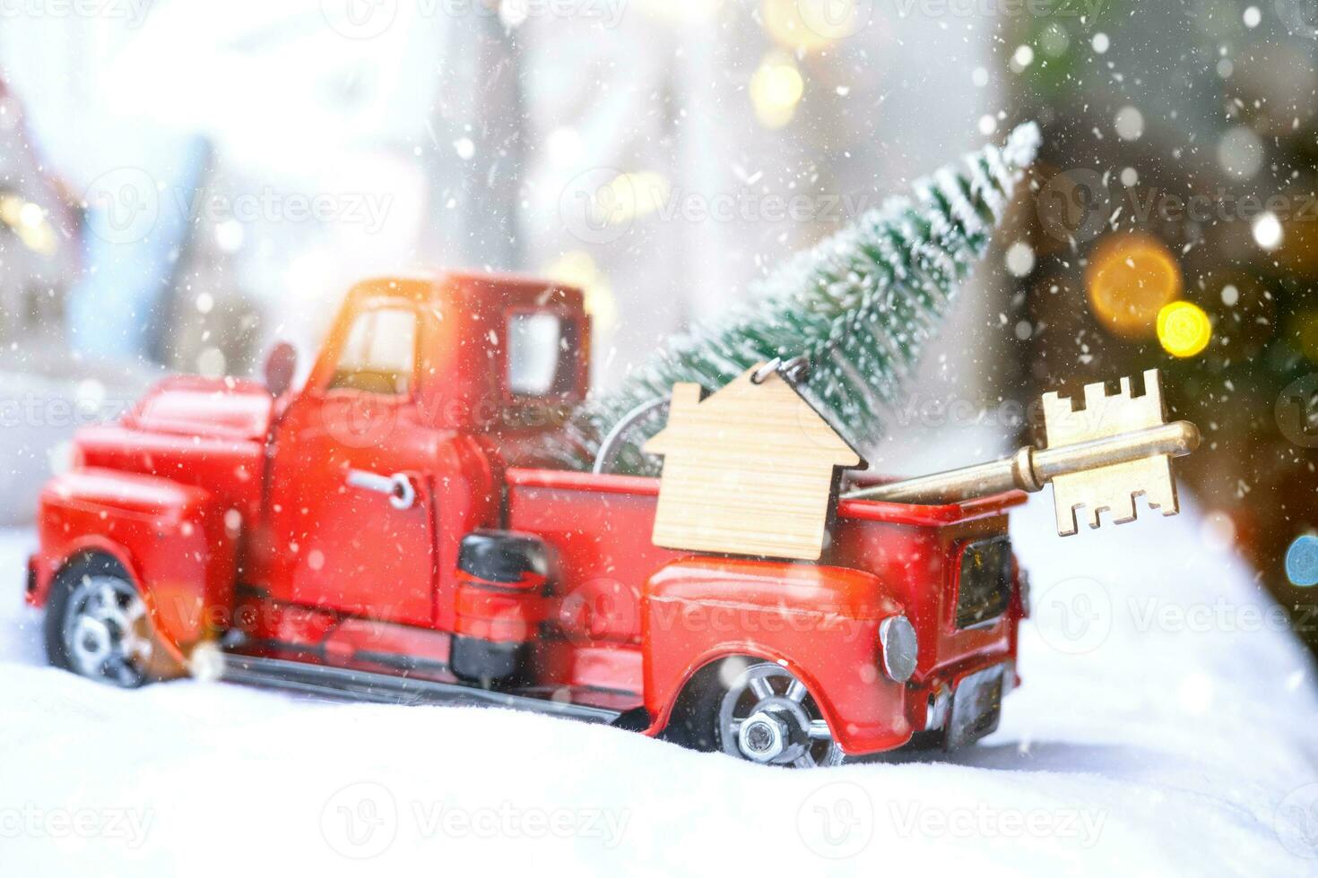 Red retro car with a Christmas tree decorates with the house key in the pickup truck for Christmas. Buying a home, moving, mortgage, loan, real estate, festive mood, New Year photo