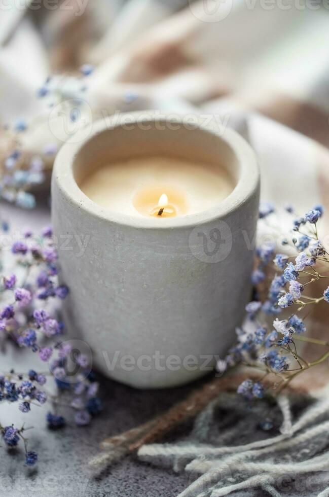 Candle and a branch of gypsophila flowers photo