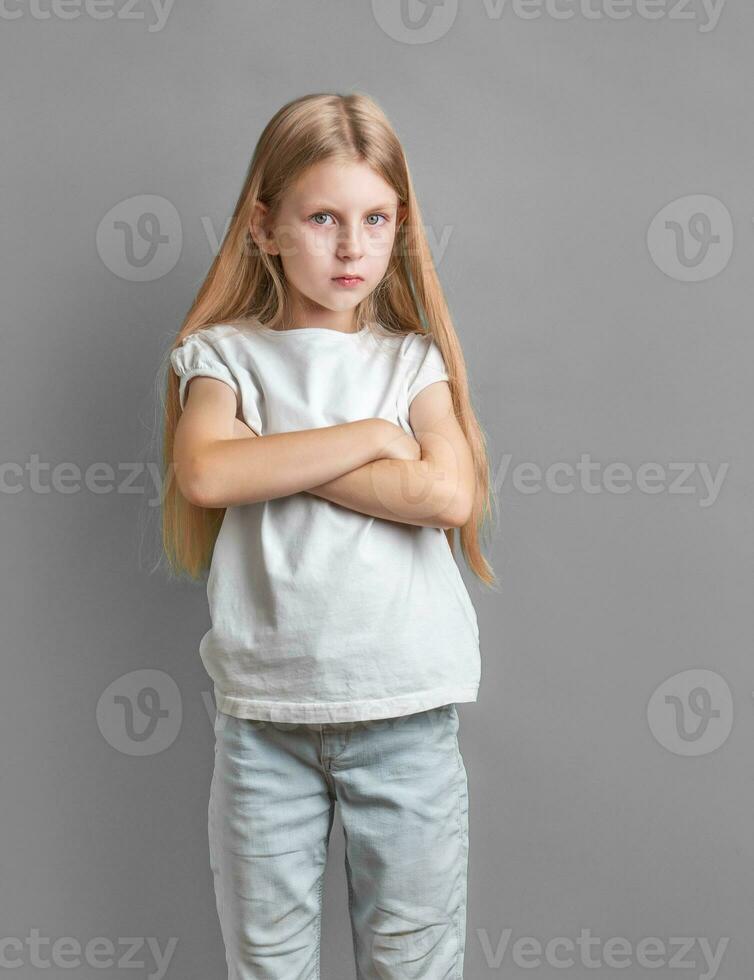 Portrait of sad little girl in white t-shirt photo