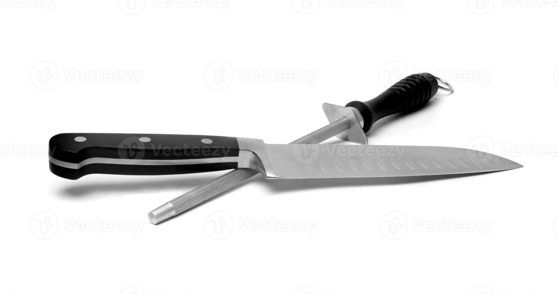 Black kitchen knife and sharpener on the white photo
