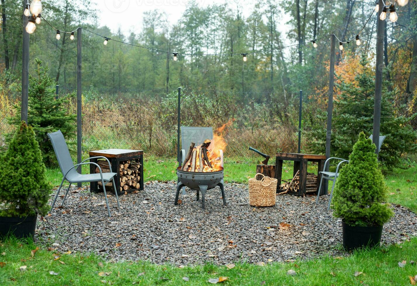 Fire pit and burning fire in a garden photo