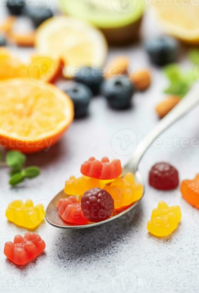 Chewable gummy vitamins and fruits photo