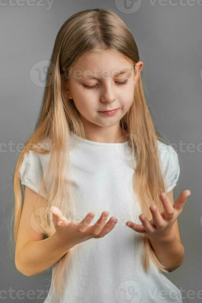 Cute little girl looking at her hands photo