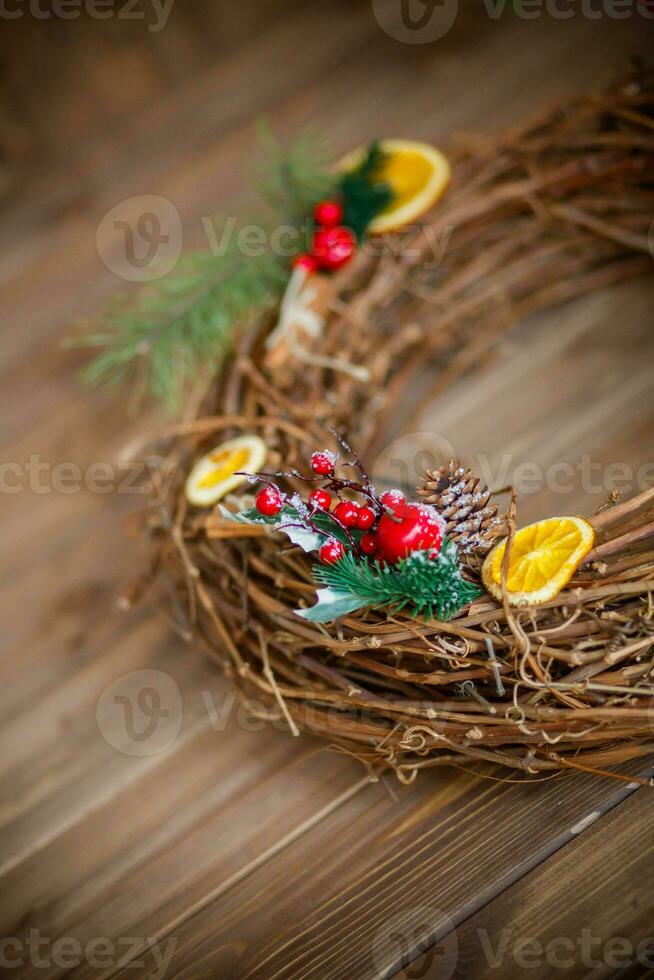 Christmas decoration with pine cones, fir branches, red berries and oranges photo