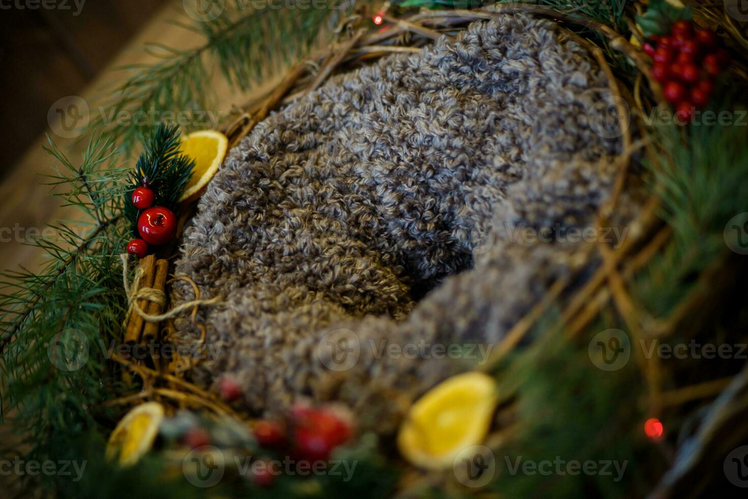 Woolen basket with Christmas decorations on a wooden background. Rustic style. photo