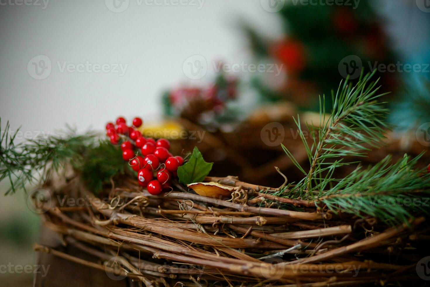 Christmas decoration with red berries on a wicker basket. Selective focus. photo