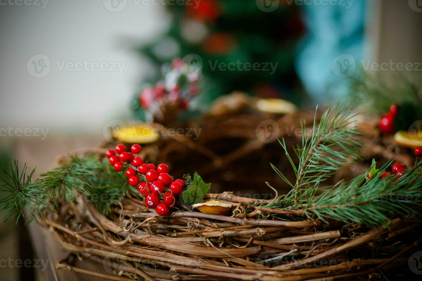 Christmas rustic wicker nest with red berries on wooden background. photo