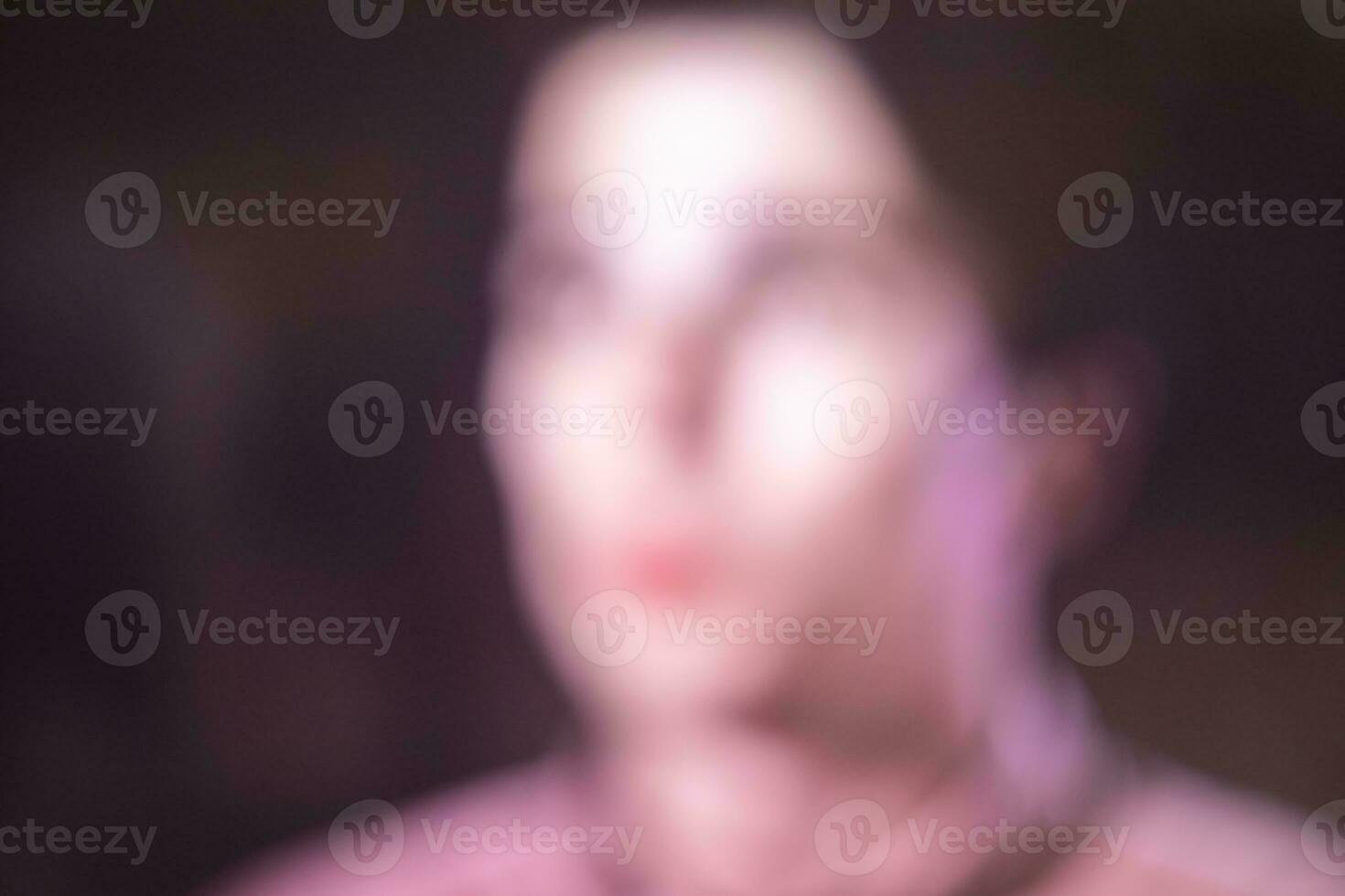 Defocused blur photo of a woman's head and face