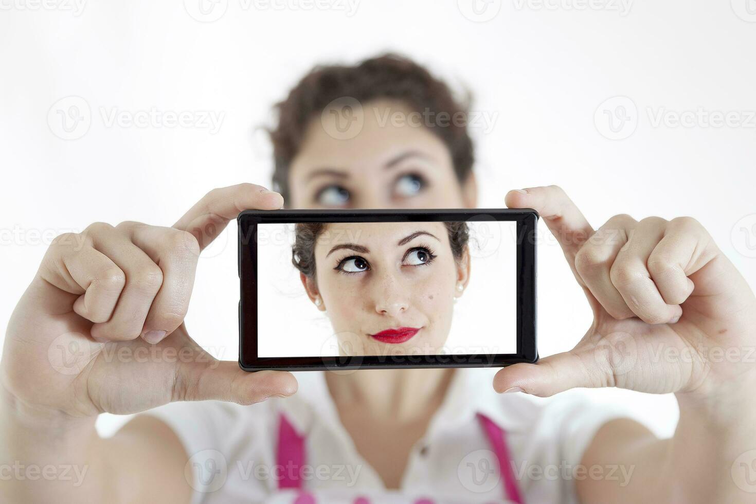 pretty woman taking a selfie using her smartphone photo