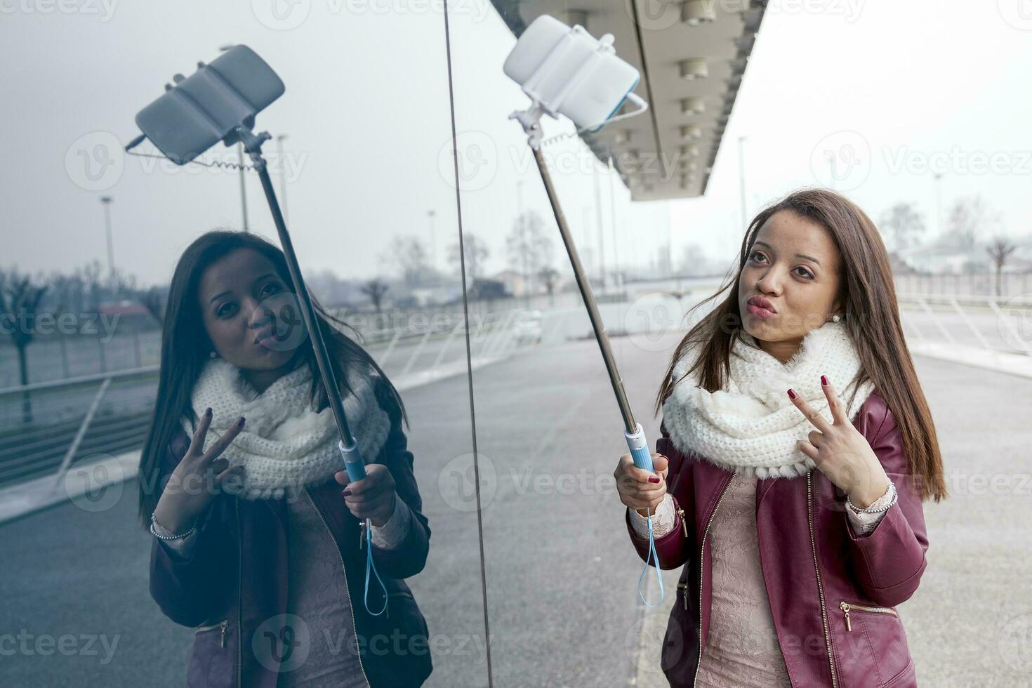 pretty young woman takes a selfie outdoor photo