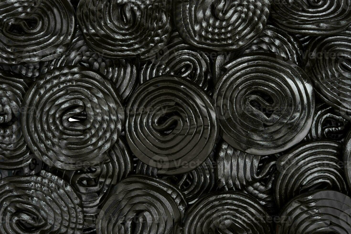 group of spiral wheels of black licorice isolated on white photo