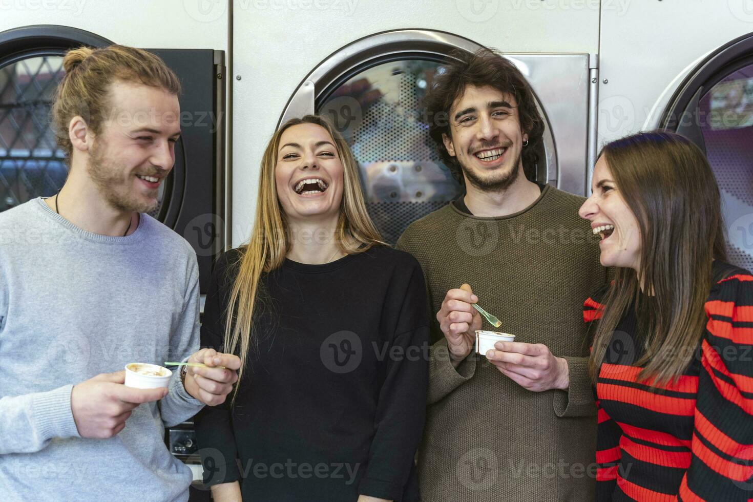 group of millennial friends are eating ice cream and washing clothes photo