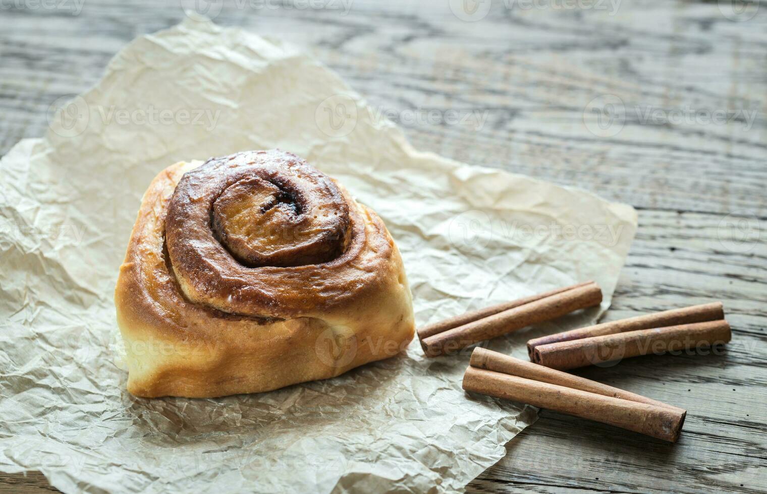 Cinnamon roll on the wooden background photo