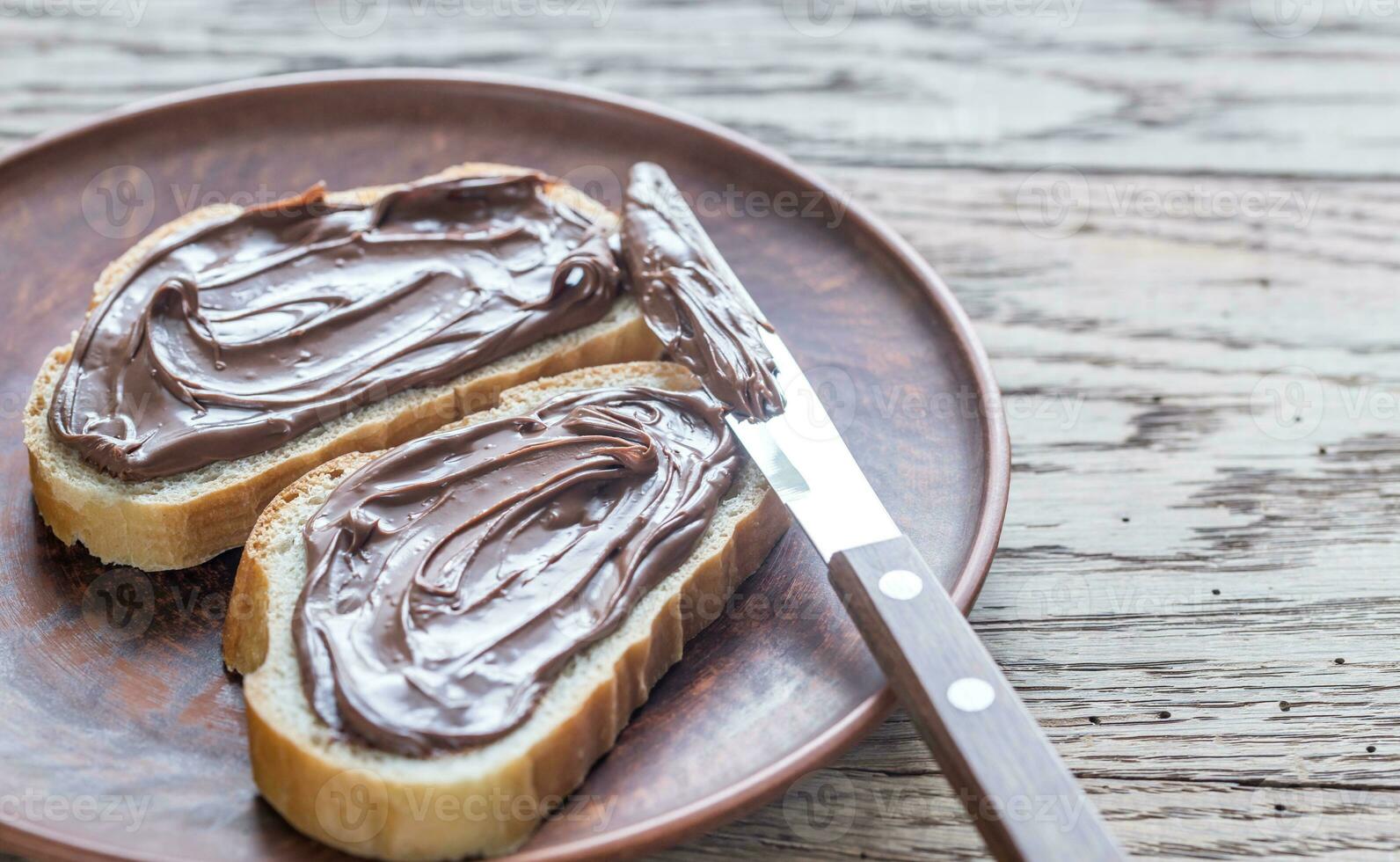 Slices of baguette with chocolate cream photo